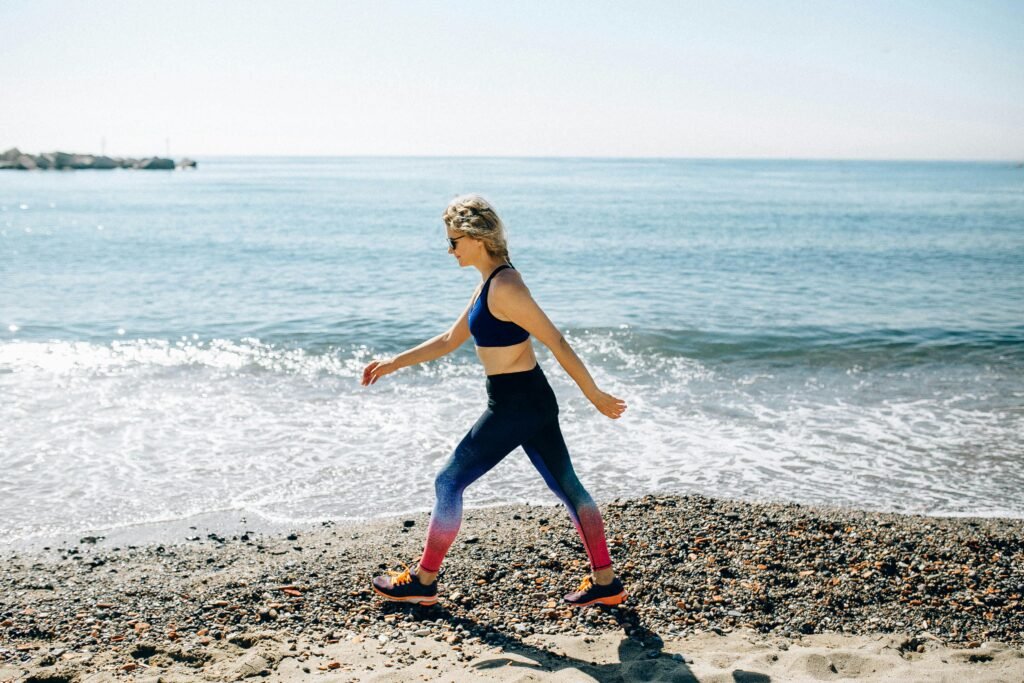 Your heart will love you if you walk everyday. Woman power walking on the beach.